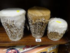 Three sets of animal skin bongo drums