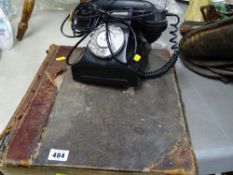 Vintage black dial telephone and a leather bound sales ledger