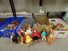 Four boxes of mainly wooden dolls and similar items