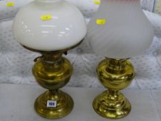 Two brass effect oil lamps with glass shades and chimneys