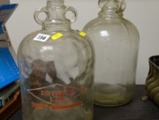 Two demi-johns, one labelled 'Dry White Ltd, West Bromwich'