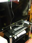 LG 32 ins TV, Sky TV box and black glass entertainment stand E/T