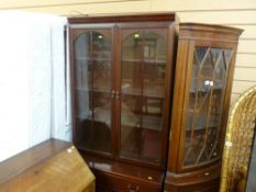Corner cupboard with upper glazed door and lower base cupboard and a dark wood compact display