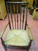Polished wood rush seated elbow chair