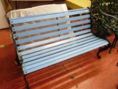 Garden bench with blue painted slats and black cast metal ends