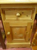 Small pine bedside cabinet with single drawer over a base cupboard