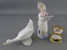 Nao figure of a belligerent goose, a Nao figurine of a young figure with a breakfast tray in hand