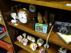 Parcel of mixed items including mantel clock, cased camera, kettle stand tile, cabinet posies etc