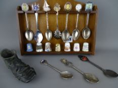 Miniature wooden rack of souvenir spoons and thimbles and a lead/pewter boot