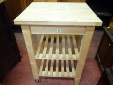 Modern butcher's block style kitchen work table with two slatted lower shelves