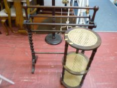 Dark wood towel airer and a circular cane three shelf whatnot
