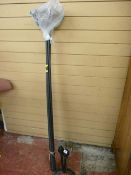 Pair of black fire dogs and a plastic chimney sweep sectional brush