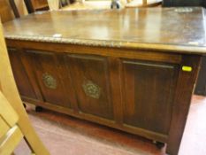 Polished wood blanket box with four front panels, the central two with floral carvings