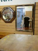 Mahogany octagonal bevelled edge mirror and a black and gilt framed bevelled edge mirror