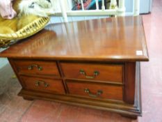 Polished wood coffee table with four drawers either side