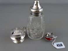 Silver mustard pot with blue glass liner, a silver topped glass sugar shaker and a white metal