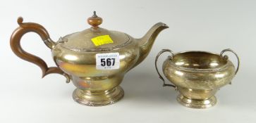 Silver circular teapot raised on pedestal base together with matching twin-handled sucrier,