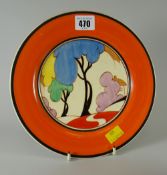 A Clarice Cliff display plate for the 'Bizarre' range, decorated with colourful trees & cottage