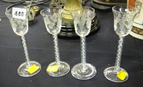 A set of four antique air-twist vases with spreading foot, the bell-shaped bowls etched with vines &