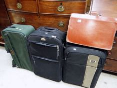 A vintage brown leather briefcase & three modern trolley suitcases Condition Report: please request*