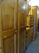 A parcel of pine furniture to include two-door wardrobe, four-drawer chest of drawers, bedside