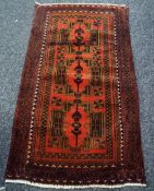 An Old Baluchi rug, 130 x 76cms Condition Report: please request* *Condition is not stated in this