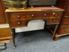 An antique mahogany low-boy having a bank of five drawers over reeded tapered supports, 96cms wide x