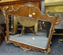 An antique gilded Rococo-style wooden mirror with shaped pane, 73cms high Condition Report: please