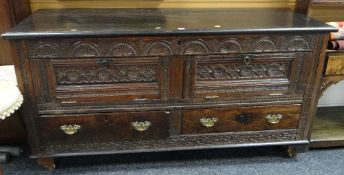 An unusual antique carved oak Lancashire-chest with two base drawers, hinged two-plank lid & the