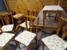 A modern pine circular breakfast table with six chairs, a slatted patio table & a circular marble