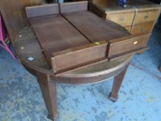 A good vintage extending circular dining table retailed by P E Gane of Cardiff together with