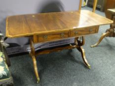 A good antique reproduction crossbanded mahogany drop-flap sofa-table with two drawers on lyre-