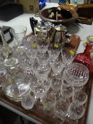 A quantity of drinking glasses, a cranberry glass decanter & a four-piece electroplate teaset ETC