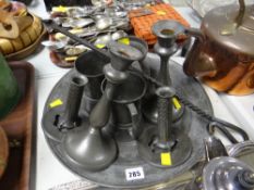 An interesting parcel of pewter including two pairs of pewter candlestick holders, three tankards