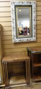 A nest of three coffee tables & a wall mirror with etched goblet decoration & with floral relief