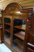 An antique mahogany dome top two-door glazed bookcase with moulded decoration to the borders &