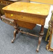 An antique walnut foldover sewing / games table with slide out basket-drawer and inlaid detail