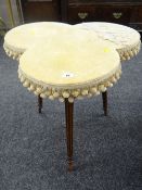 An antique lobed table on three reeded and ebonized supports and with velvet covered top Condition