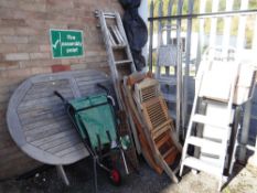 A large teak garden table, parasol, chairs, step ladders ETC (outside) Condition Report: please