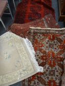 A parcel of four rugs including two red & blue ground geometric patterned Middle Eastern rugs