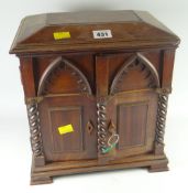 A good antique mahogany architectural style table-top chest of three drawers, concealed behind