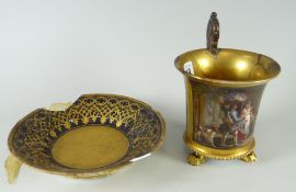 A Continental porcelain cabinet cup on three-claw feet with painted scene of market traders & dog,