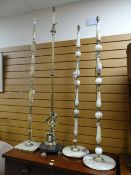 Four various standard lamps Condition Report: please request* *Condition is not stated in this