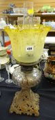 An antique cast metal oil lamp with glass reservoir & tinted shade Condition Report: please request*