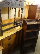 An open bookcase, a three-drawer chest with painted top, a linen fold side table & a leather