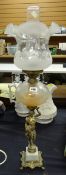 An antique brass & marble based figural oil lamp with etched clear glass reservoir, conforming