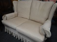 A good patterned upholstery two-seater wing back sofa Condition Report: please request* *Condition