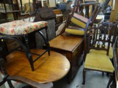 An antique mahogany drop leaf table on twist supports, four chairs, a music / dressing table stool