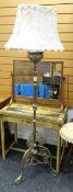 An antique brass tripod standard oil lamp converted to electrical use & with elaborate decoration to