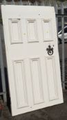 A large painted white pitch pine three-panelled front door together with a cast iron knocker (